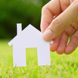 Hand holding paper house