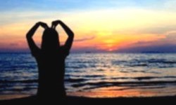 Girl creating a heart shape with hands